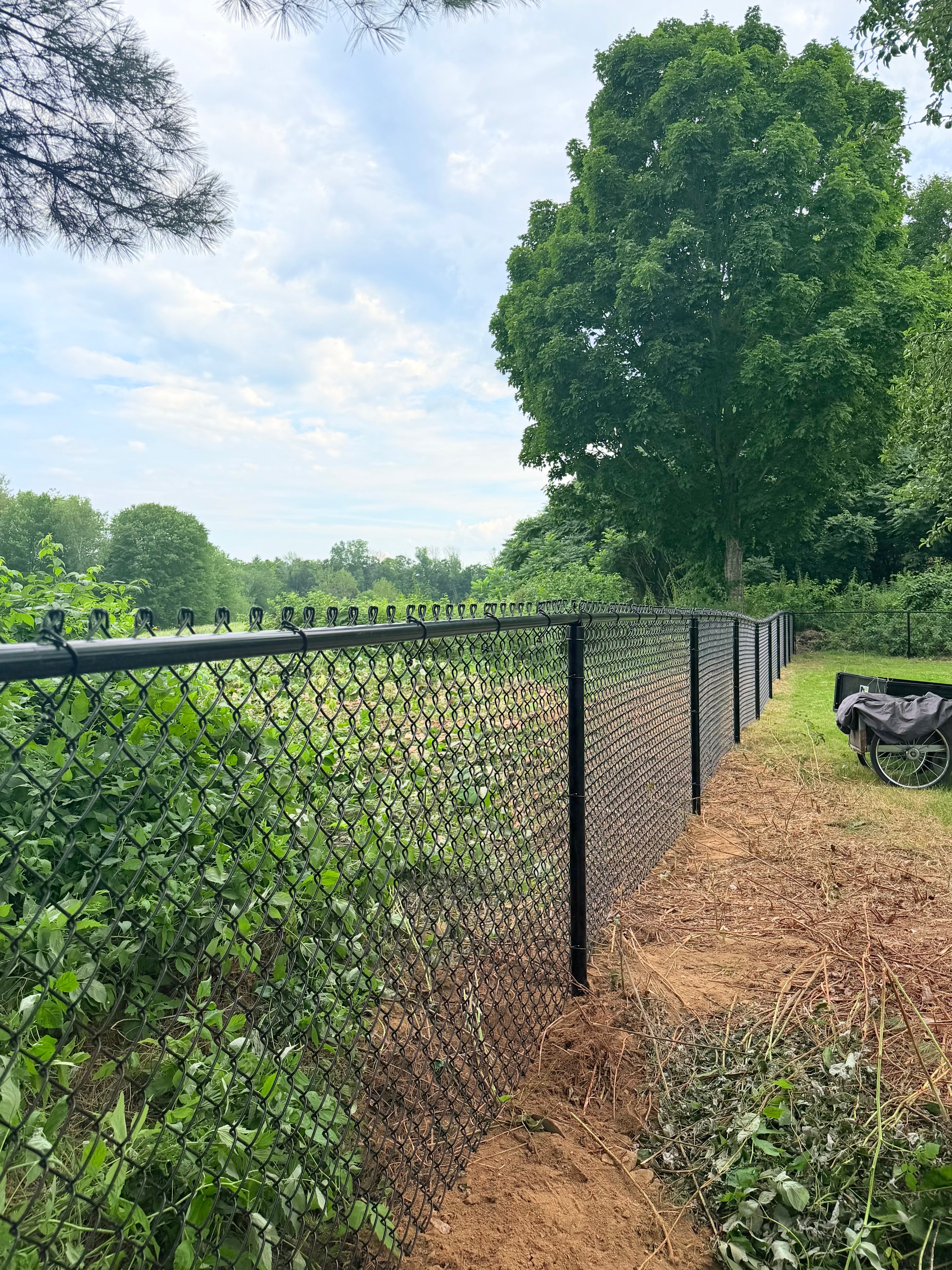 Black chain link fence installation close-up by Ultra Fence LLC