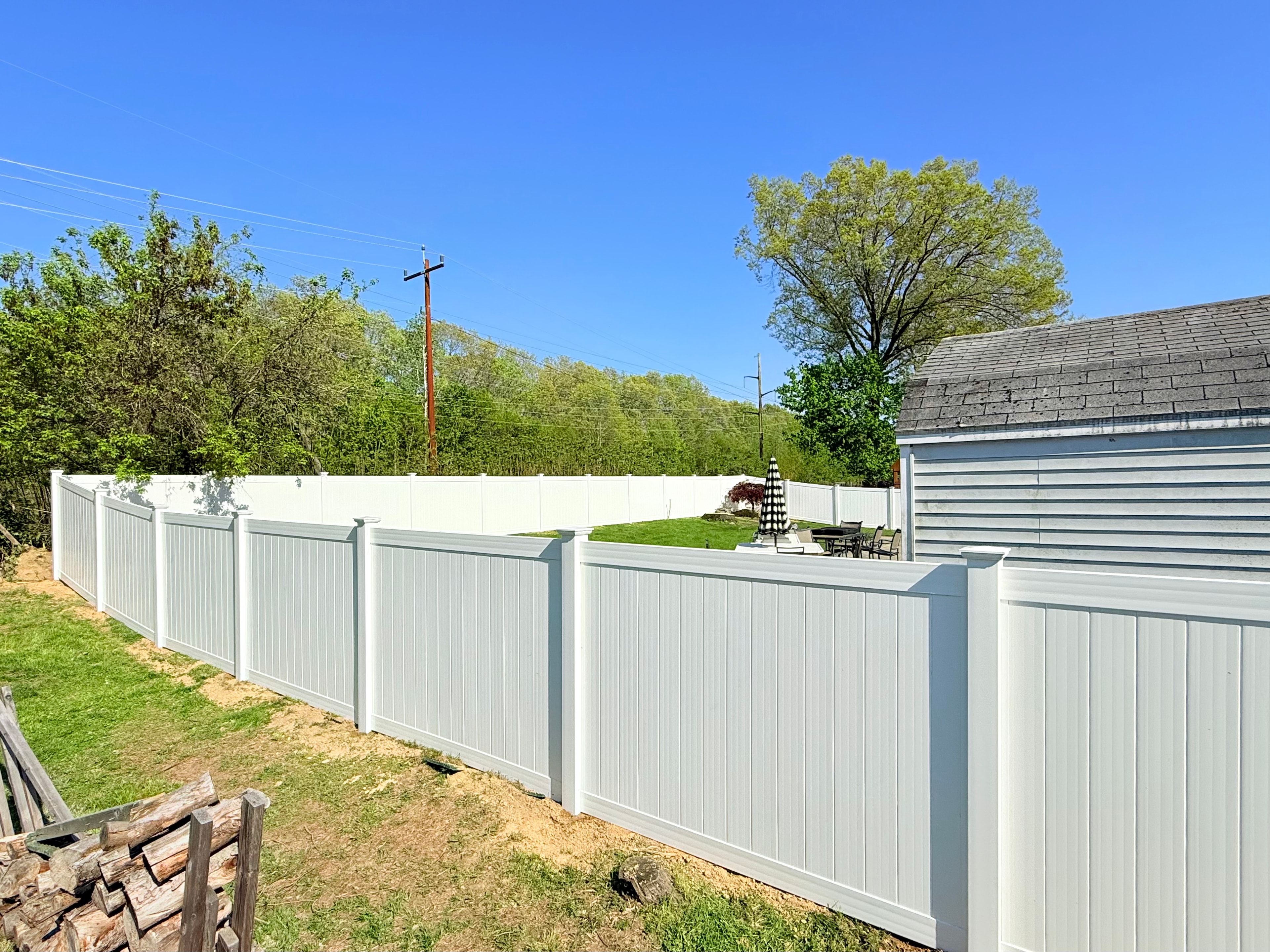 Two-tone gray and white vinyl privacy fence installed by Ultra Fence LLC